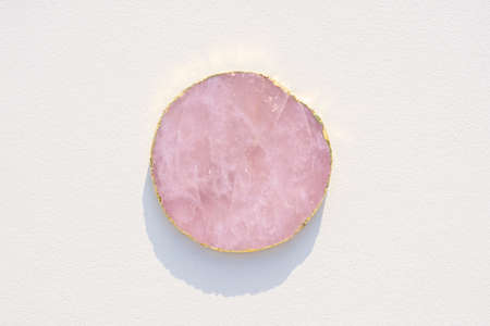 Pink marble podium for product presentation on white background. Empty cylindrical platform for...
