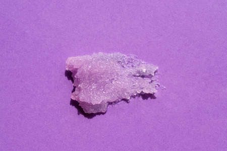 Sugar body scrub texture on a purple background. Cosmetic smear. Appearance of the texture of the lilac swatch. Natural skincare products. Beauty concept for face and body careの写真素材