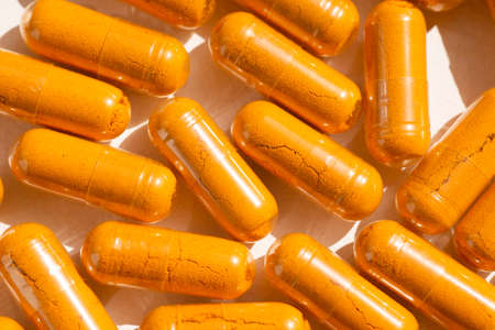 Turmeric plus black pepper extract gelatin capsule close up top view. Herbal supplement organic...