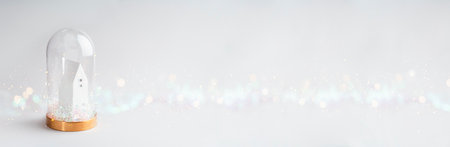 Christmas cute little house in glass dome with base. Glowing festive garland on white background...