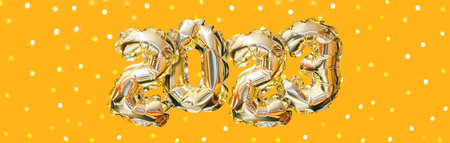 Helium golden balloon number of year 2023. Glowing festive garland with bokeh on orange background. Happy New Year bannerの写真素材
