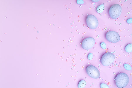 Bunch of colorful eggs with dots on purple background. Minimal Easter concept with copy space for text.の写真素材