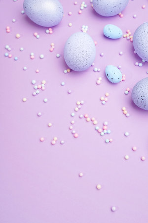 Bunch of colorful eggs with dots on purple background. Minimal Easter concept with copy space for text.の写真素材