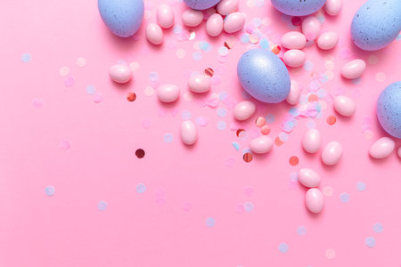 Easter postcard with bunch of candy eggs on pink background. Minimal Easter concept with copy space for text. Festive day backdrop. Flat lay style.の写真素材