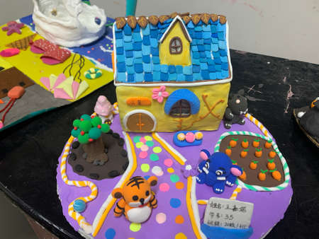 Board with delicious cake on table. Cake decorating with fondant.の写真素材