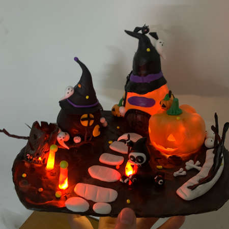 Halloween cake with pumpkins, witch and ghosts on white backgroundの写真素材