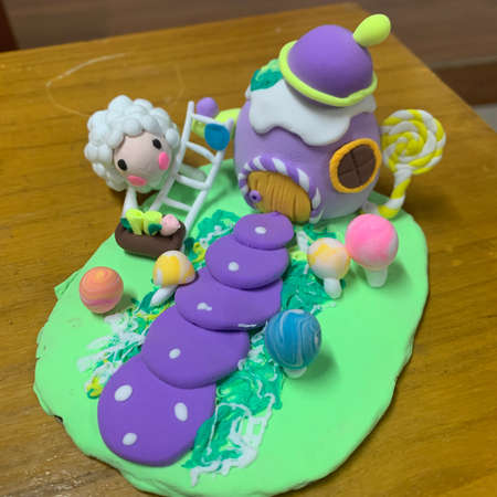 A vertical closeup shot of a cake with a unicorn and a sheepの写真素材