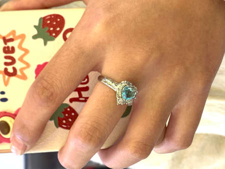 Diamond ring on hand of a young woman, close-up.の写真素材