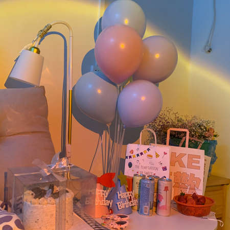 A vertical shot of a birthday party decoration with balloons and other itemsの写真素材