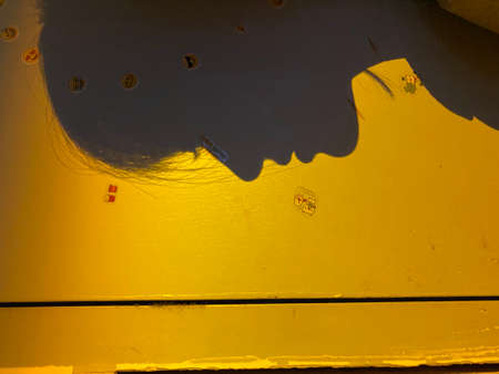 Close-up of a piece of yellow paint on the wall.の写真素材