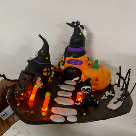 Halloween pumpkin cake decorated with black and orange pumpkins and witch hatsの写真素材