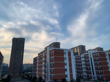 Aerial view of modern residential high rise apartment buildings under cloudy blue sky.の写真素材