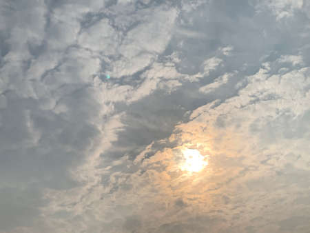 The sun shines through the clouds in the sky. High quality photoの写真素材