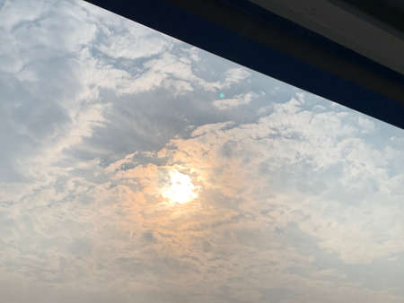 Clouds in the sky. The sun shines through the window.の写真素材