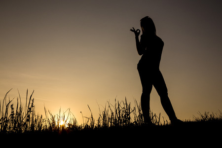 female silhouette with ok signの写真素材