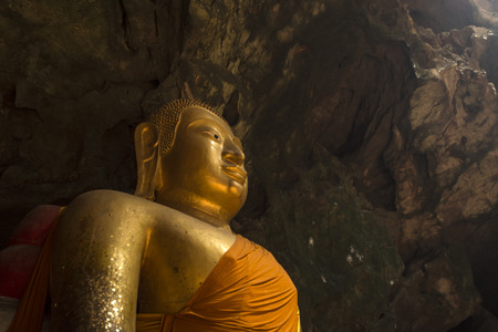 Big image of Buddha in the cave from Petchaburi, Thailand  Here is call  Thum-Khao-Luang   Its have a big flue to letの写真素材