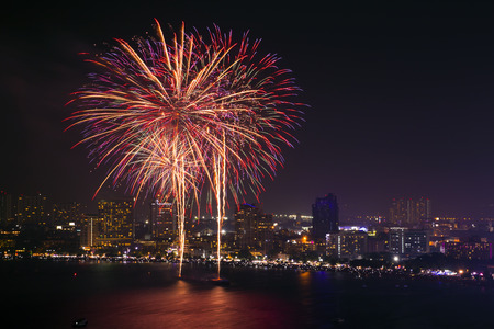Red   Violet firework action on the beachの写真素材
