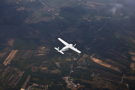 An airplane fly over the framland for sight seeing.の写真素材