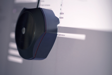 A calibrator position on the computer monitor display to bigin calibration for accuracy color job with shallow focusの写真素材