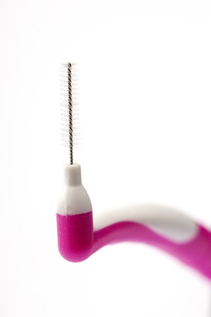 The interdental brush close-up isolated on white backgroundの写真素材
