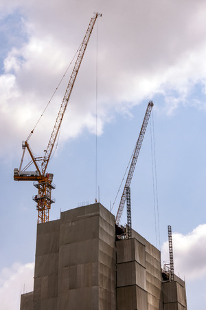 The building under construction with complete cover blue sky backgroundの写真素材