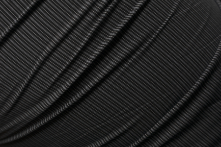 A wrinkle black and white fabric with line pattern background texture shallow focusの写真素材