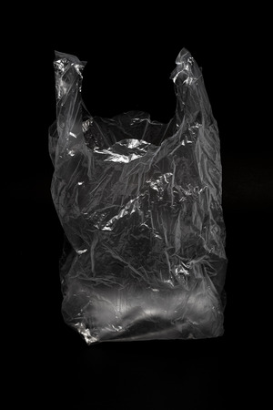 The empty transparency plastic bag isolated on black backgroundの写真素材