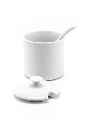 A mini white bowl with spoon and open cover in set isolated on white backgroundの写真素材