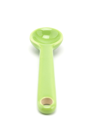 A green cutie spoon isolated on white backgroundの写真素材