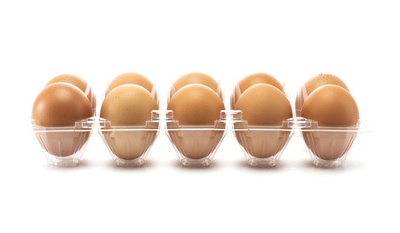 A ten eggs in side the open plastic packaging isolated on white backgroundの写真素材