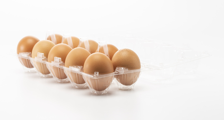 A ten eggs in side the open plastic packaging isolated on white backgroundの写真素材