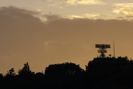 A rotation type radar on the moutain in silhouette styleの写真素材