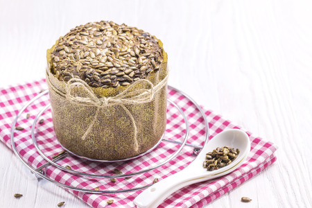 Sunflower Bread with crumbs, New Year Cloth, Teaspoons on White Tableの写真素材