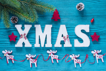 Christmas Wood Decoration in Turquoise and Red Color with Xmas Tree, Pine Conesの写真素材