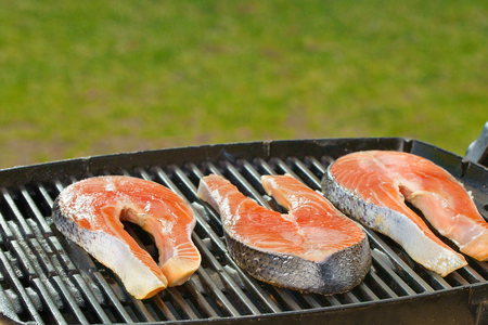 Delicious  portion of fresh salmon fillet on a grill or BBQの写真素材