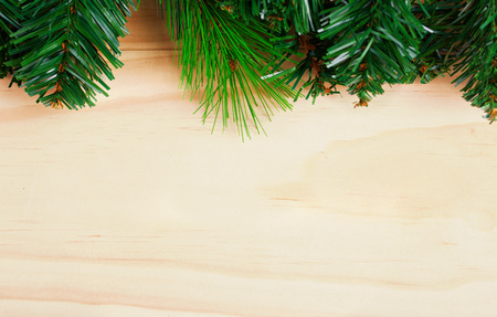 Green fir-tree branches on wooden background. Space for textの写真素材
