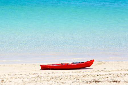 Red canoe on sandy beachの写真素材