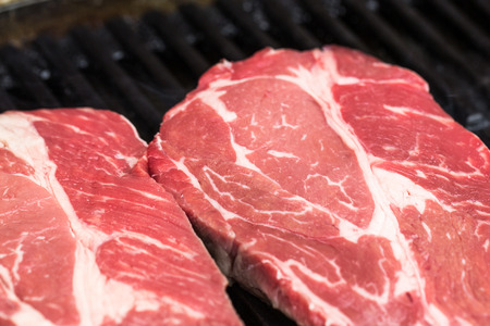 Fresh beef steaks on grill or BBQの写真素材