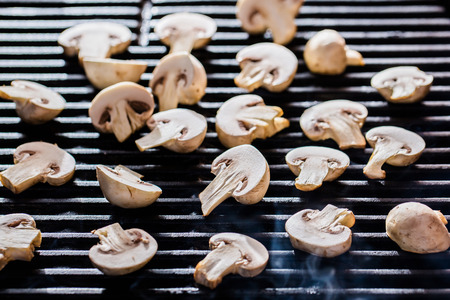 Champignon mushrooms on grillの写真素材