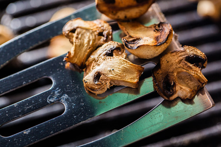Grilled champignon mushrooms on spatulaの写真素材