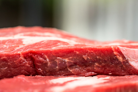 Fresh beef steaks on wooden boardの写真素材