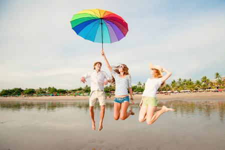 Group of happy young people having fun on the beachの写真素材
