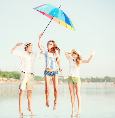 Group of happy young people having fun on the beachの写真素材