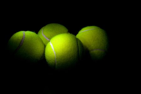 Tennis balls on a black backgroundの写真素材