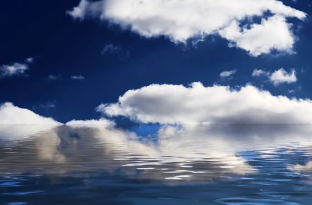 dramatic deep blue sky with white clouds and water