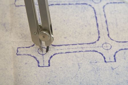 drawing circle with a compass on a old blueprint