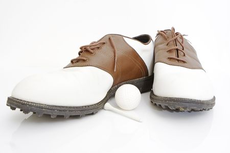 golf shoes ball and tee isolated against white backgroundの写真素材