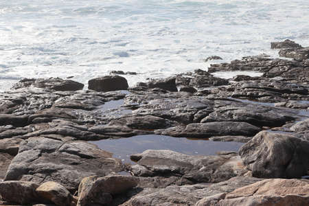 Rocks at Camelle Beach, Costa da Morte, Galicia, Spain. Mountains can be seen in the background. Beach of Aleman.の写真素材
