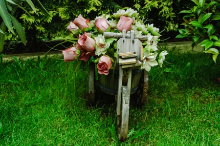 Cart of wood with flowers adorning the gardenの写真素材
