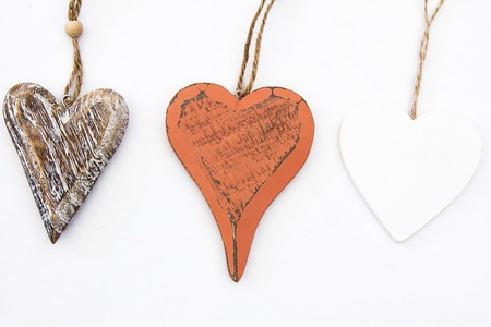 Three Wood Heart Shapes on White Backgroundの写真素材